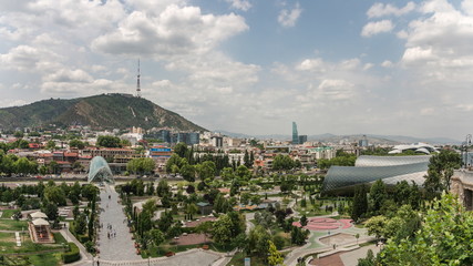 Obraz premium The view to Rhike Park in capital city of Georgia, Tbilisi. Contrast of the modern and ancient part of the city.