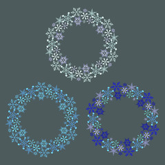 Beautiful wreaths of white snowflakes on a gray background. Template for winter and new year cards.