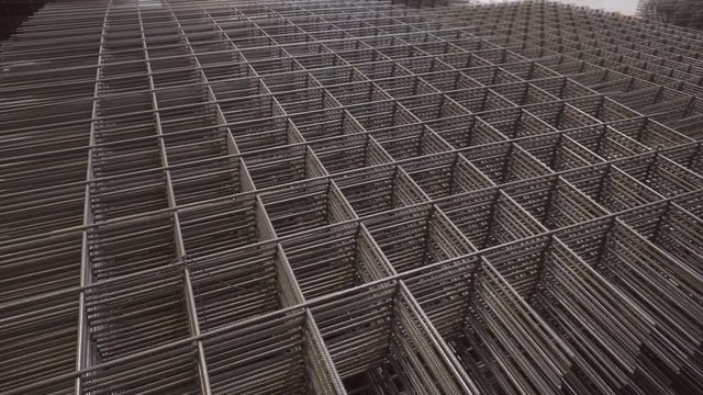 Reinforcement mesh close-up. Armature made of wire. Metal rockstores, reinforcement in reinforced concrete sheets. Building material, background texture.