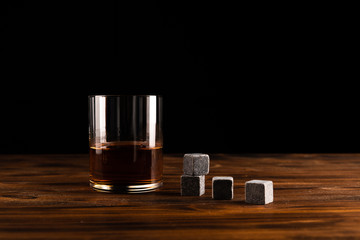 Glass of whiskey with stones. Selective focus