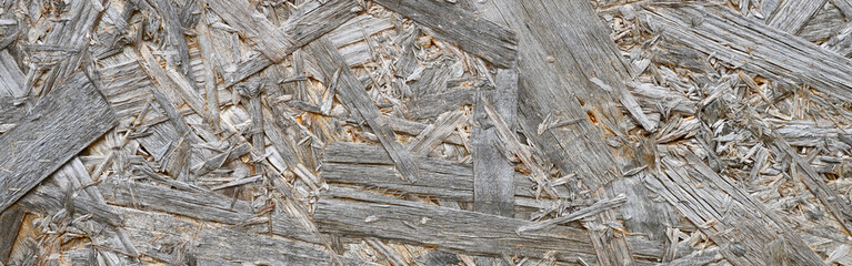 plywood gray color. background texture of aged sheet of plywood with fragments of compressed sawdust. banner