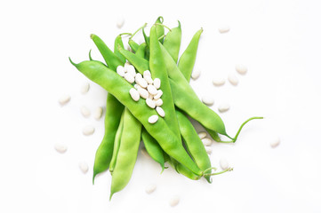 Fototapeta premium Uncooked dried white haricot beans with fresh raw green beans pod plant isolated on White background. Heap of legume haricot bean ( Phaseolus vulgaris )