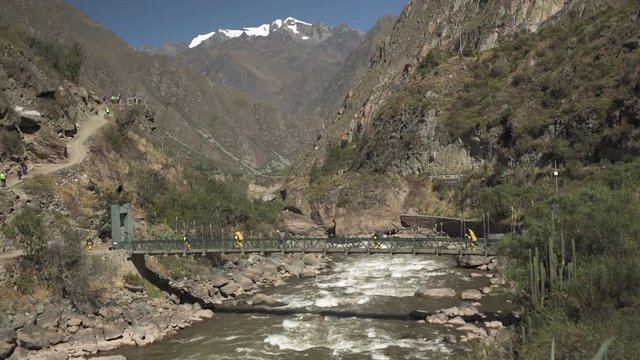 WS group of people crossing suspension bridge on Inca trail. Cusco, Peru