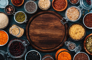 Zero waste and sustanable lifestyle. Plastic free storage and cooking concept. Various organic superfoods, beans, grains, cereals, legumes, seeds in reusable cans and jars. 