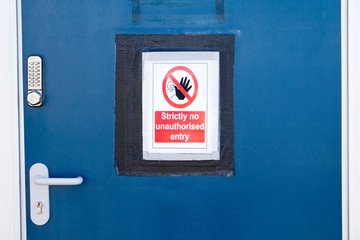Strictly no unauthorised access sign at construction site security door