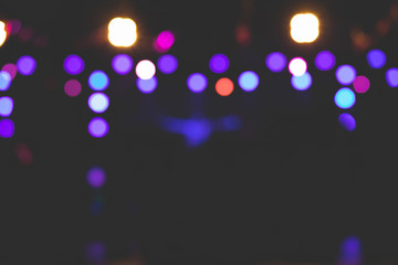 The beautiful background image of bokeh from various lights on the stage at night.