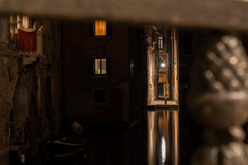 view of a water canal and a beautiful narrow street in Venice Italy