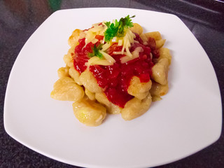 Homemade gnocchi with tomato sauce and meat
