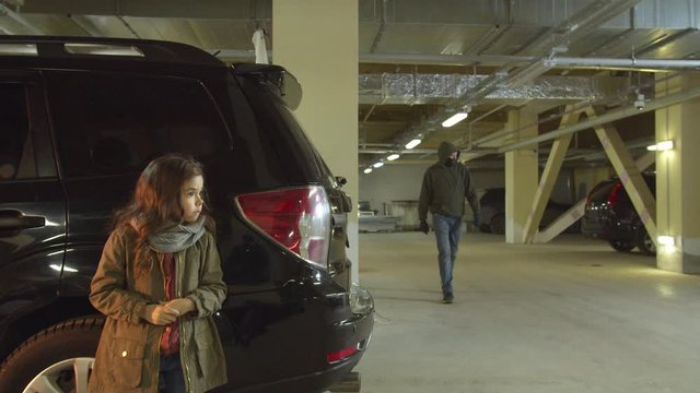 Girl hiding from a kidnapper in the parking lot