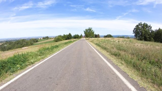 secondary paved road through green rural fields next to Costamezzana (Noceto), Province of Parma, Emilia-Romagna, Italy