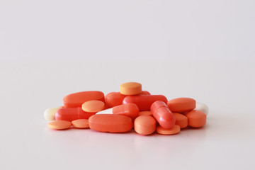 A lot of orange pills, capsules and tablets