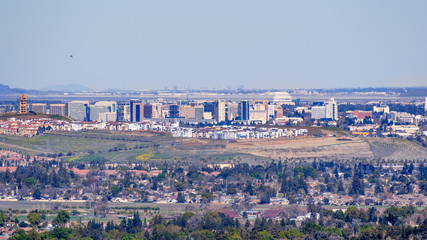 Aerial view of the San Jose downtown skyline on a clear day; residential neighborhoods visible in...