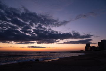 Naklejka na ściany i meble Beautiful sunset sky on beach at Povoa de Varzim, Portugal with buildings in silhouette