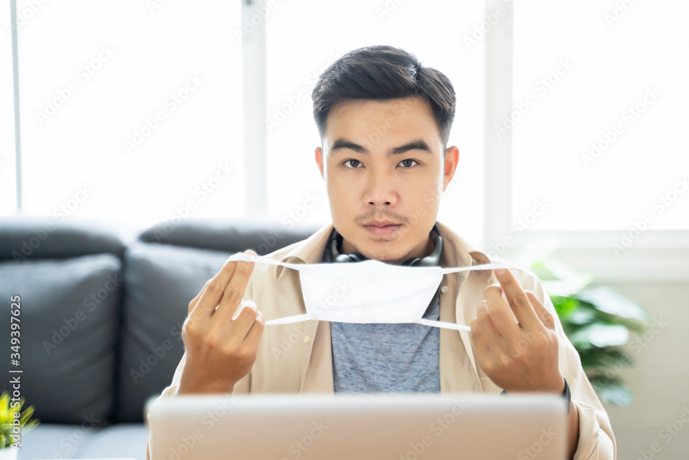 Poster asian man putting on protective mask working from home web designing graphical user interface ux ui,