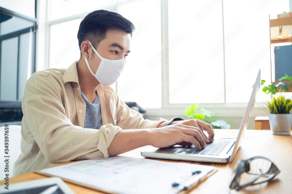 Fototapete Working from home web designing graphical user interface UX UI, using computer laptop and tablet device designing creative planning innovative idea, protective facemask quarantine coronavirus covid-19