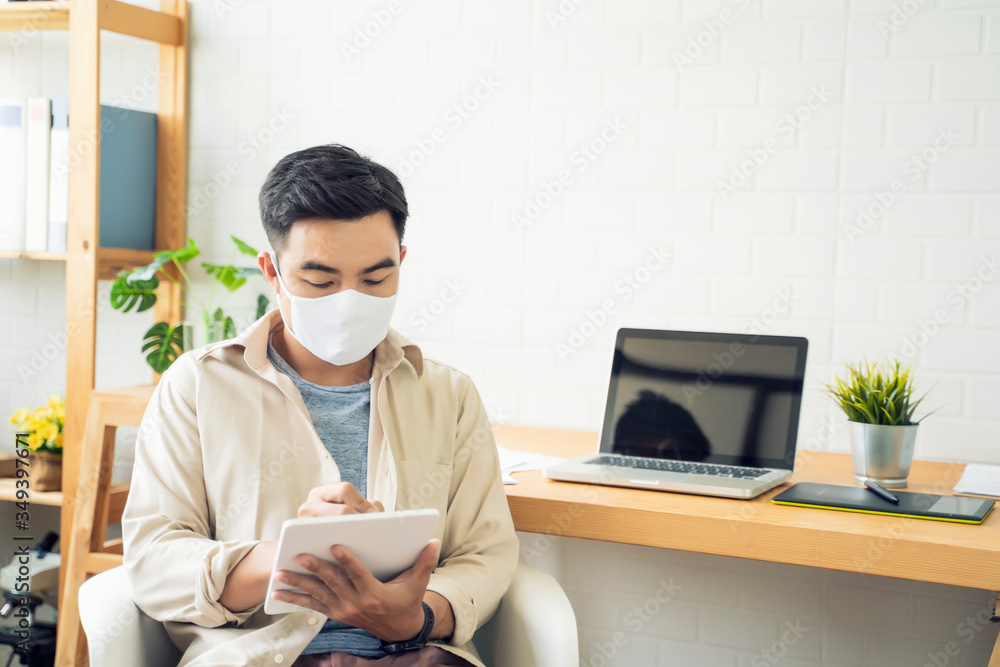 Fototapete Working from home web designing graphical user interface UX UI, using computer laptop and tablet device designing creative planning innovative idea, protective facemask quarantine coronavirus covid-19