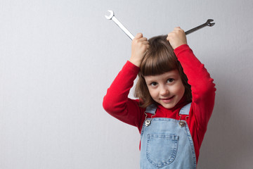Funny little girl plays with keys and holds them near her head