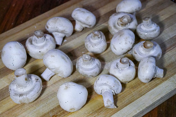 White and fresh mushrooms on wooden table