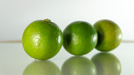 The full lime has a reflection on the ground.