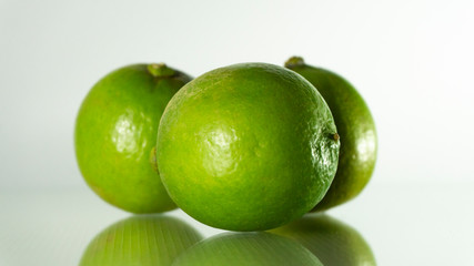 The full lime has a reflection on the ground.