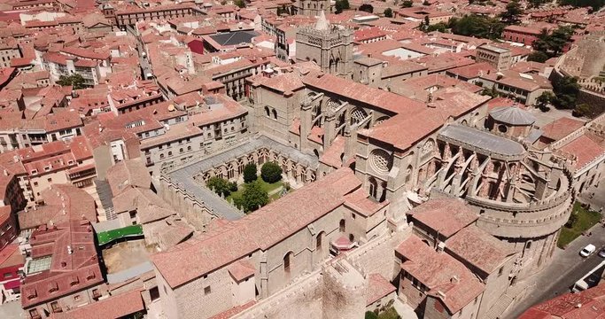 Aerial view of Gothic Cathedral of Saviour in Spanish fortified city of Avila on background of cityscape in summer day