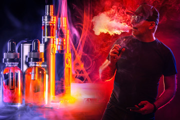Smoking electronic cigarettes. VAPE shop. A man smokes a VAPE on a red and black background. A...