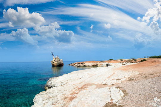 Cyprus beach. White stone. A stranded ship off the coast of Cypr