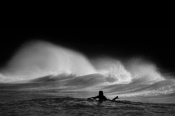 Black and White photo of a surfer surfing at Tamarama Beach, Sydney Australia