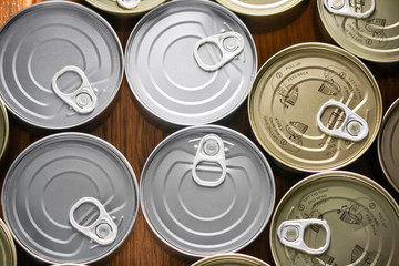 various tuna cans in gold and silver color from a top view