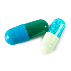 Two medicine pills isolated on a pure white background
