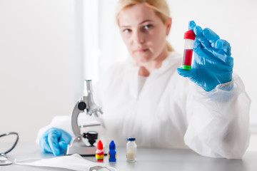 Woman working with a microscope in lab