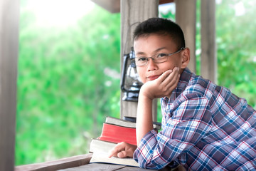 Fototapeta premium Happy boy reading the Bible on wooden table, Christian concept.
