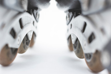 closeup to the wheels of used roller skates.