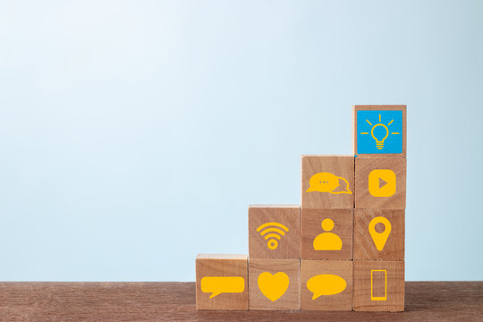 Wood cube block with social media on wooden table. Social media and success concept