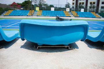 Fototapeta premium empty blue plastic seats in a stadium summer mid day