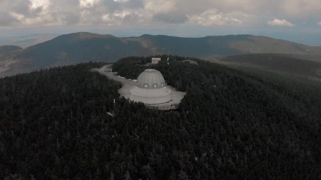 Mont Megantic Observatory Situated At The Summit Of Mont Megantic With Glorious Green Forest In Quebec, Canada.-  aerial drone shot