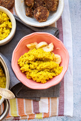 Yellow cooked millet grain cereal porridge for breakfast