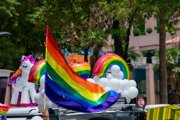 Símbolos de la comunidad LGTB, como  el aroiris y la bandera de arcoíris, bandera LGBT o bandera LGTB ha sido utilizada como símbolo del orgullo gay, lésbico, bisexual y transexual - obrazy, fototapety, plakaty