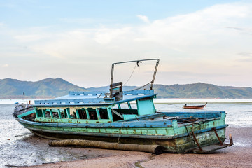 Fototapeta premium Old boat at low tide on Ko Yao Noi island in Phang-Nga Bay near Phuket in southern Thailand