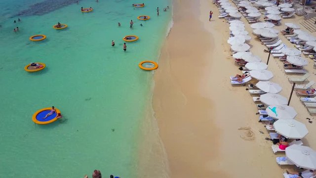 People Sunbathing and Swimming Marriott Beach Resort Cayman Islands Caribbean\