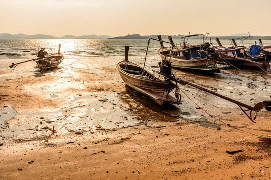Beached boats at low tide during golden hour on Ko Yao Noi island in Phang-Nga Bay near Phuket, Thailand