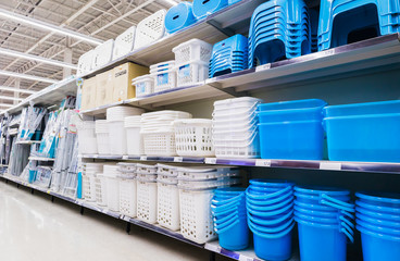 Plastic baskets,Containers and plastic chairs on shelves at grocery store supermarket.
