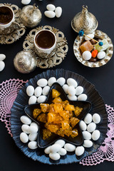 Traditional Turkish Hard Candies Almond and Akide on black background with Turkish Coffee.The Sugar Feast.