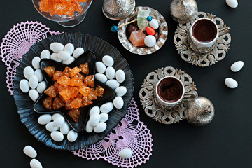 Traditional Turkish Hard Candies Almond and Akide on black background with Turkish Coffee.The Sugar Feast.