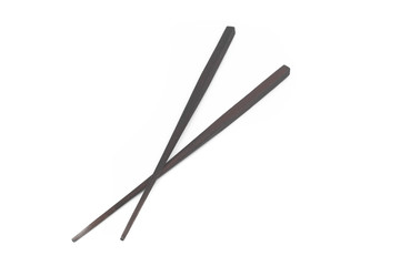Close up a pair of chopsticks over white background.