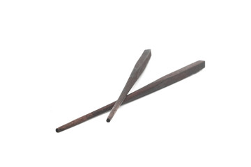 Close up a pair of chopsticks over white background.