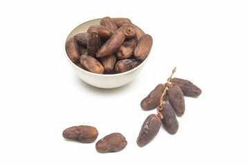 Dates over white background. In Malaysia during Ramadhan month which is fasting month in Islam, dates are very popular because of providing rapid energy through out the day.