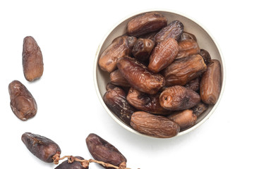 Dates over white background. In Malaysia during Ramadhan month which is fasting month in Islam, dates are very popular because of providing rapid energy through out the day.
