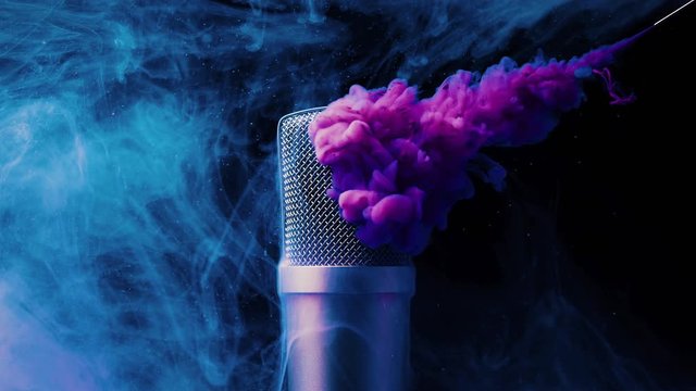 Purple paint spilling onto a microphone in water