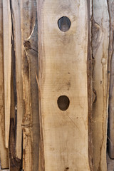 Knot holes in a oak board. Unedged oak lumber. Wooden texture